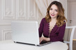 © Надежда Манахова - Beautiful woman is sitting in an expensive kitchen behind a laptop. Work at home, realtor, online store.