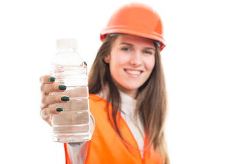 Smiling beautiful woman giving bottle of water