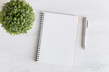 Wall Mural - flat lay photo of office desk on white background,empty notebook open on white wood table