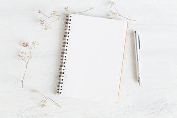 Wall Mural - flat lay photo of office desk on white background,empty notebook open on white wood table