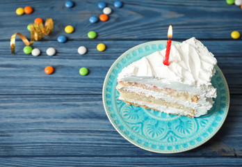 Poster - Piece of birthday cake with candle on table