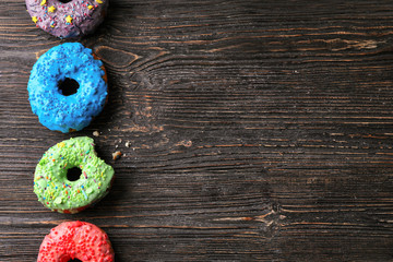 Wall Mural - Tasty donuts on wooden table