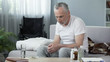 © motortion - Depressed senior male sitting on sofa at nursing home, loneliness and melancholy