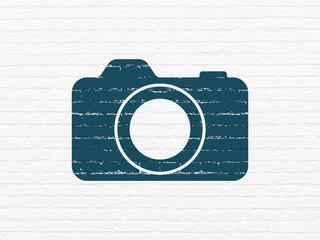 Canvas Print - Tourism concept: Painted blue Photo Camera icon on White Brick wall background