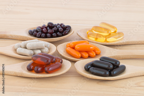Fotografie, Obraz Healthy Vitamin supplement capsules in a spoons.