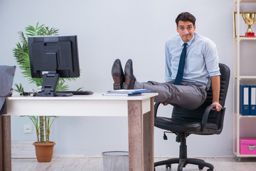 Businessman doing sports in office during break