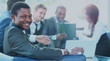 © ASDF - Portrait of smiling African American business man with executives working in background