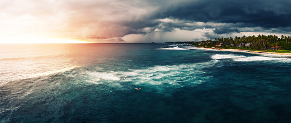 Wall Mural - Panorama of the surf spot named Coconut with surfers on the line up. Stormy weather surfing conditions