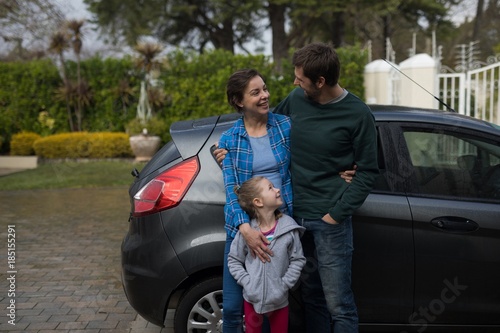 Fotografia, Obraz Father, mother and daughter standing near the car