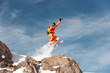 © yanik88 - An athlete skier is jumping from high rock high in the mountains.