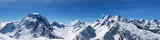 Fototapeta Góry - Panoramic view of snow-capped mountain peaks