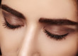 © marinafrost - Perfect shape of eyebrows, brown eyeshadows and long eyelashes. Closeup macro shot of fashion smoky eyes visage