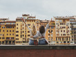 © Aila Images/Stocksy - Two tourist girl friends looking amazed arms raised peace sign a