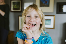 Young Girl Wiggling Loose Tooth