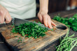 © Gabriel (Gabi) Bucataru/Stocksy - Woman's hands chopping fresh parsley