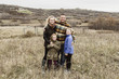 © Carey Shaw/Stocksy - Outdoor portrait of happy family together