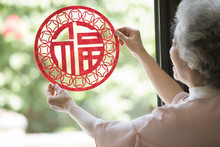 Senior Woman With Chinese New Year Paper-cut