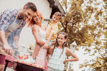 Poster - Family having a lunch in their garden in summer.