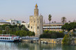 Golden tower (Torre del Oro) at sunset from the other side of the Guadalquivir river, Seville (Andalusia), Spain.