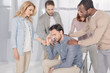 © LIGHTFIELD STUDIOS - mid adult multiethnic people supporting upset man during group therapy