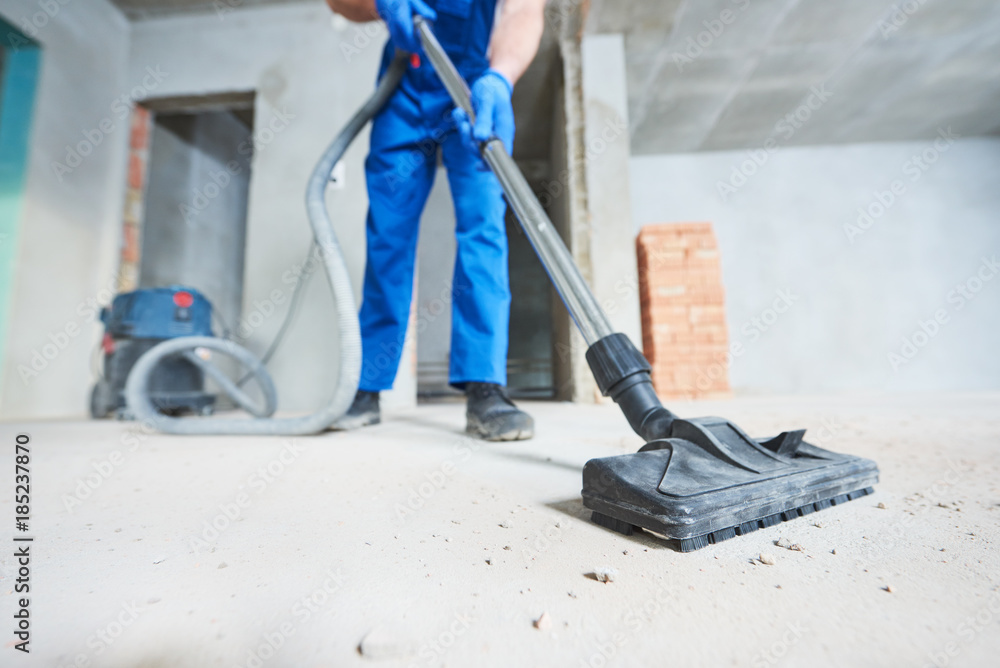 construction cleaning service. dust removal with vacuum cleaner - obrazy, fototapety, plakaty 