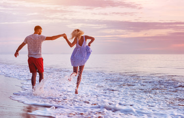 Happy couple at romantic sea sunset