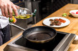 © LIGHTFIELD STUDIOS - cropped image of chef pouring oil on frying pan