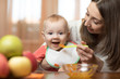 © Oksana Kuzmina - Baby eating healthy food with mother help at home