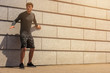 © Wisiel - Young male jogger athlete training and doing workout outdoors in city.