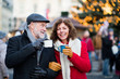 © Halfpoint - Senior couple on an outdoor Christmas market.