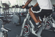 Man's legs on exercise bike in fitness club, healthy lifestyle