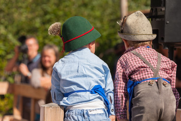 Young children in typical costume during an autumn local celebration in Val di Funes ( South Tyrol )