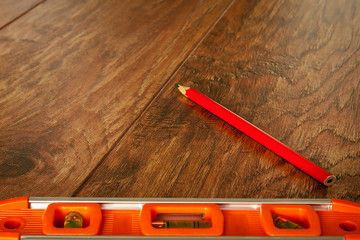 Canvas Print - Optical level and a pencil lying on the floor