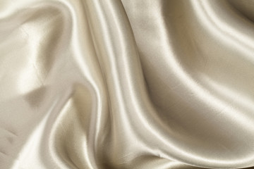 Silk background, texture of beige  shiny fabric