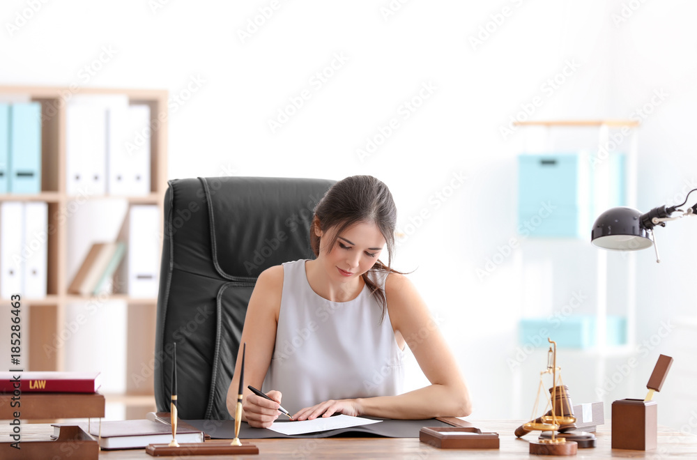 Young female notary working in office