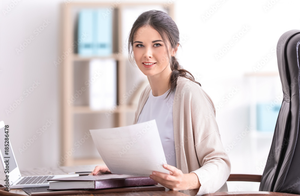 Young female notary working in office