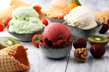 Wall Mural - Set of ice cream scoops of different colors and flavours with berries, nuts and fruits