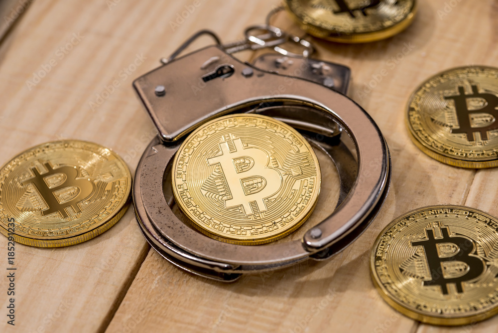 handcuff and gold bitcoin. crime conception