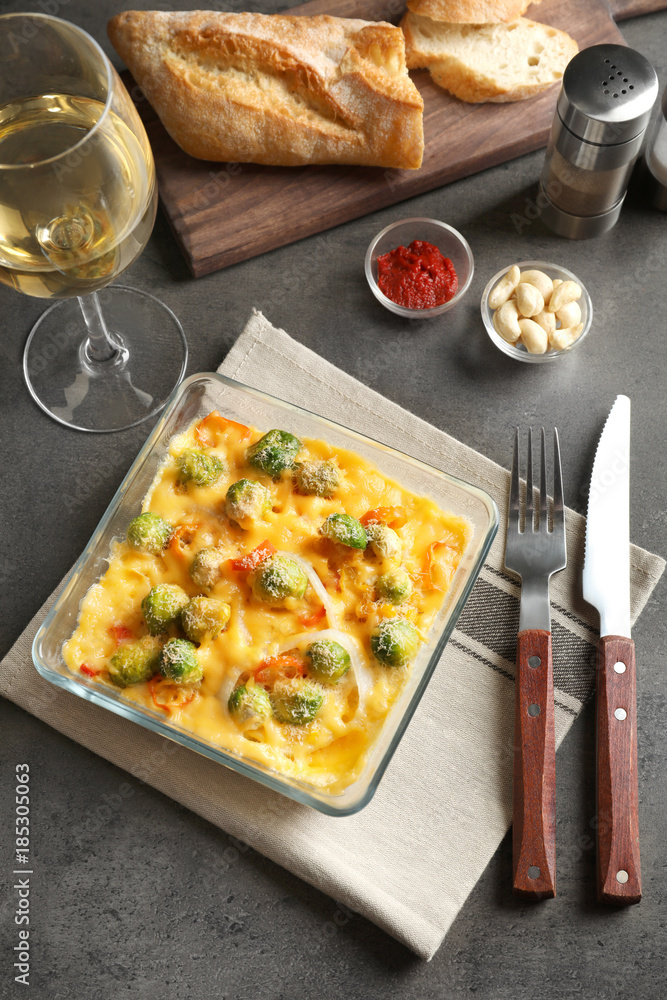 Baking dish with yummy brussel sprouts casserole on table