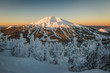 The snow covered Cascade Mountains and frozen trees at sunrise in winter