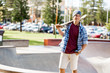 © Sergey Nivens - Teenage boy with skateboard standing outdoors