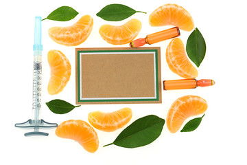 Wall Mural - vitamin C Mock up. ampoules with vitamin C, syringe, slices  mandarin and brown paper board on white background. Serum with Vitamin C