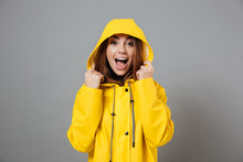 Portrait Of A Joyful Girl Dressed In Raincoat