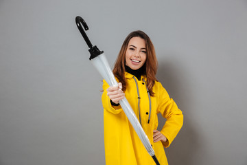 Wall Mural - Portrait of a cheerful girl dressed in raincoat