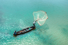 Fisherman Casting His Net In The Brahmaputra River , Assam, India.