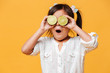 Little cute girl child covering eyes with lime.
