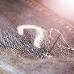 Wall Mural - A question mark with chalk on the jeans, the needle and thread