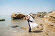 © myronovychoksana - Newlyweds walk along the shore