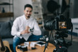 © LIGHTFIELD STUDIOS - technology blogger wearing new smart watch with camera on foreground