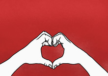 Cropped Hands Of Person Making Heart Shape Against Red Background